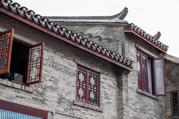 Fototapeta na wymiar Close-up of ancient building exterior walls and plants in a Chinese style garden