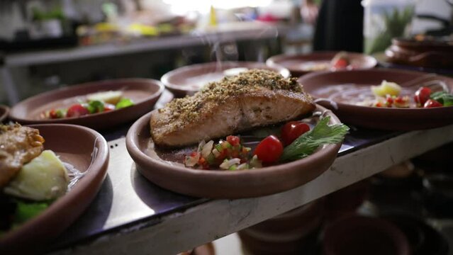 Seafood. Steamy grilled salmon with vegetables dish in the restaurant kitchen table.