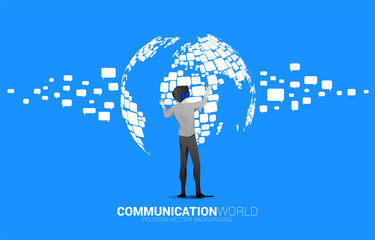 Silhouette businessman wear VR glasses with group of speech bubble icon shape to world map . concept of communication network in metaverse. © Panithan