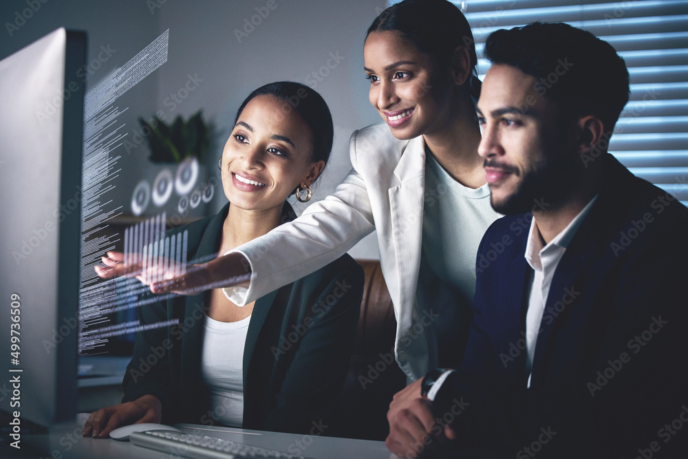 Poster Interactive business is the future. Shot of a young group of businesspeople using a computer while working in the office at night.