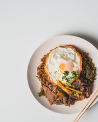 Thailand Food : Stir-fried beef and basil with fried egg on green plate Thai food concept.Thai street food.