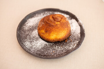delicious homemade cinnamon roll on friin plate on elegant vintage wooden table