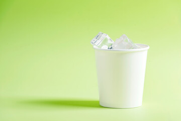 White plastic cup with ice cubes