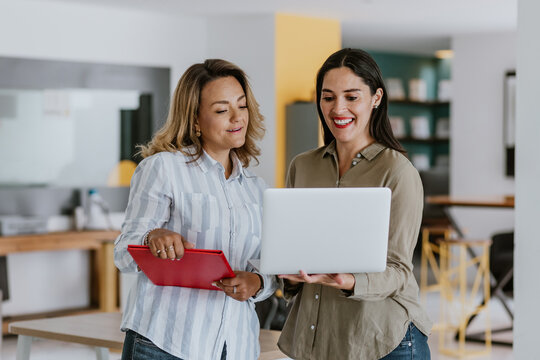 Two Latin Business Woman Middle Age Working With Computer At The Office In Mexico Latin America	