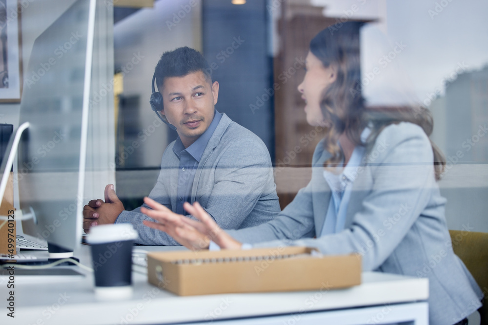 Poster Helping a colleague is as important as helping a client. Cropped shot of two young call center agents working at their desks in the office.