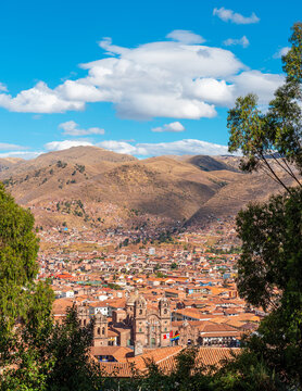 Vertical aerial city skyline of ancient inca capital Cusco with Compania de Jesus church and Plaza de Armas square, Cusco province, Peru.