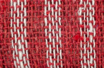 The texture of natural fabric. Perpendicularly woven white and red cotton threads. Kitchen towel or napkin.
