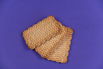 Three rectangular cookies against a blue background. Ready-to-eat treats with peanuts.