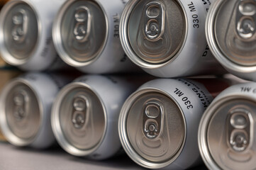 Geometric composition of full tin cans. Drinking water in silver individual beverage containers.