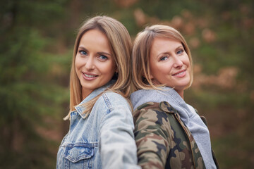 Fototapeta premium Two girl friends or lgnt couple in wood