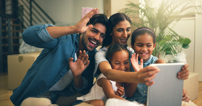 Connecting With Family Far Away. Cropped Shot Of A Young Family Making A Video Call On A Tablet At Home.