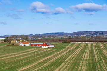 Fototapeta na wymiar Landscape view in spring with a farm on a field