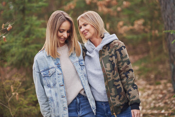 Fototapeta premium Two girl friends or lgnt couple in wood