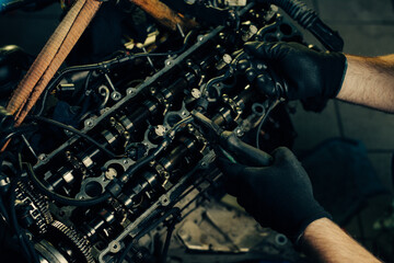 Fototapeta na wymiar Auto mechanic working and repair on car engine in mechanics garage