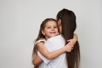 Happy woman and child girl 5-6 years old having fun