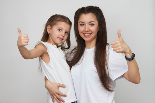 Happy woman and child girl 5-6 years old having fun
