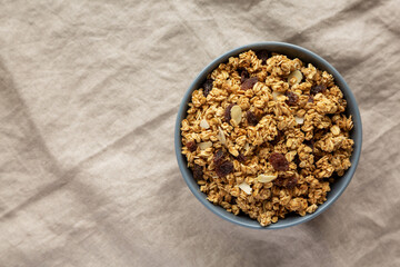 Homemade Granola with raisins and almonds  in a Bowl, top view. Overhead, from above, flat lay. Copy space.