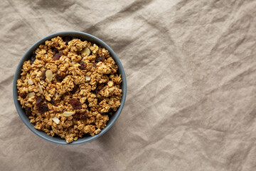 Homemade Granola with raisins and almonds  in a Bowl, top view. Overhead, from above, flat lay. Space for text.
