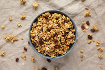 Homemade Granola with raisins and almonds  in a Bowl, top view. Overhead, from above, flat lay.