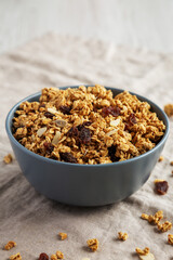 Homemade Granola with raisins and almonds  in a Bowl, side view.