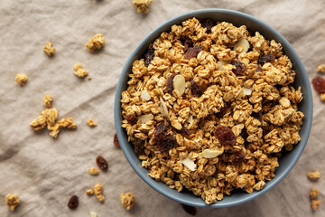 Homemade Granola with raisins and almonds  in a Bowl, top view. Overhead, from above, flat lay.