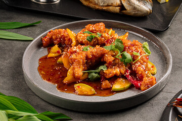 Portion of cooked walleye fish with sweet and sour sauce