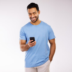 A sweet text a day keeps sadness away. Studio shot of a young man using a phone against a grey...