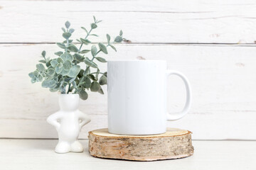 Fototapeta na wymiar White ceramic mug on a light background