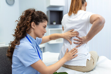 Physiotherapist doing healing treatment on womans back. Back pain patient, treatment, medical...