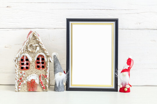 Black frame 10x15 on the table with holiday symbols.