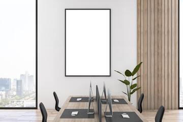 Modern wooden and concrete coworking office interior with empty mock up poster on wall, furniture, equipment, technology and window with city view. 3D Rendering.