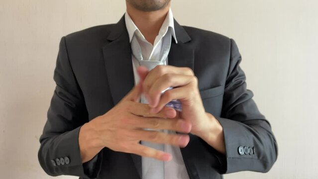 Frustrated asian male businessman professional crumpling paper with written message "LIE" word. Man in suit and tie having nervous breakdown furiously throwing crumpled paper at work in office