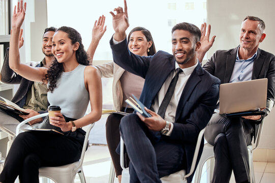 Weve all got questions. Shot of a group of businesspeople raising their hands in a meeting at work.