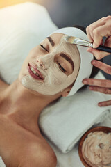 This is heavenly. Shot of an attractive young woman getting a facial at a beauty spa.