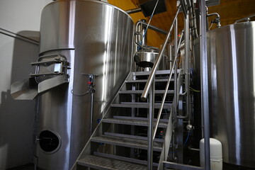 Photo of indoor stairs from large stainless steel tanks to beer production - 499749159