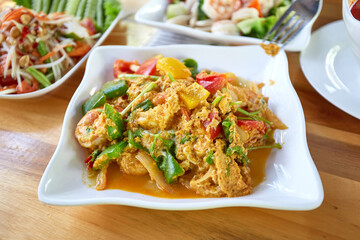 Stir Fried Shrimp with Curry Powder on wooden dining table. Thai food.
