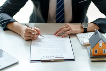 Real estate agent and customer make contract to buy and sell house and land. Approval of a contract to buy or sell a home. Offers mortgage loans and home insurance concept.