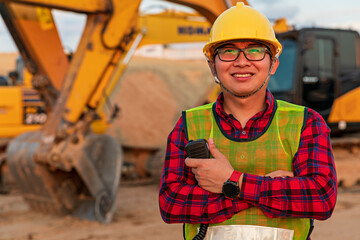Asian engineers use walky talky with team for earthmoving project by excavator. foreman use laptop...