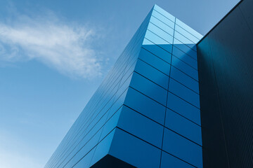 Geometric colored building facade elements with planes, lines and corners with light flare and reflections for an abstract background and texture of white, blue, gray colors. Place for text
