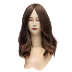 Natural hair wig on a mannequin on a white isolated background. Brunette, long wavy hair. Front view