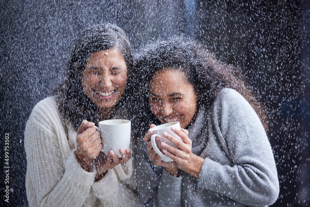 Wall mural Talk about a snowy Christmas. Shot of two best friends standing outside in the snow during Christmas while holding coffee mugs.