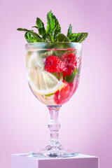 Raspberry and lemon refreshing summer infused water on podium