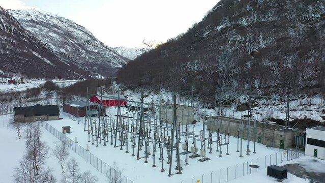 High voltage transformer and distribution station for hydroelectric powerplant in Borgund Norway - Aerial gently rotating around facility