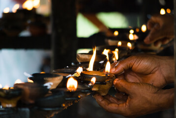 Traditional oil lamps in a buddhist temple - obrazy, fototapety, plakaty
