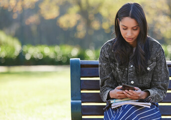 No reply Its been hours. Shot of a beautiful young student using her phone while sitting outside.