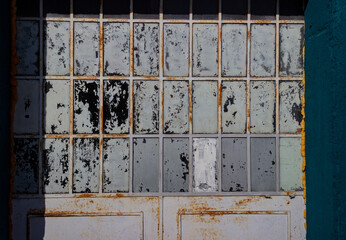 Detail of the door of an old factory. Industrial vintage background.
