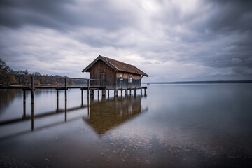 Traditional boathouse at lake Ammersee near Munich, Bavaria, Germany at sunrise.