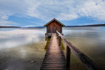 Traditional boathouse at lake Ammersee near Munich, Bavaria, Germany at sunrise.