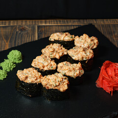 Bright sushi on a dark wooden background	
