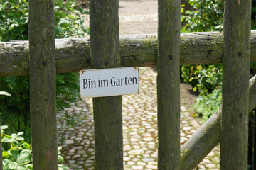 Garden door with a sign saying I'm in the garden